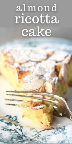 a close up of a fork on a plate with a piece of pie in the background