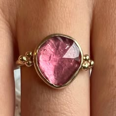 This freeform pink tourmaline is set in 14k yellow gold with gold accent beads, brilliant white diamonds and Emily's signature gold band. Approximate stone size: 12mm x 10mm Mohs Hardness: 7-7.5 Each piece is handmade with love in our Hudson Valley studio. This ring is one of a kind and currently ready to ship at size 7.5. Free resizing is available prior to shipping. Wall To Wall Carpet, Pink Stone Rings, Metal Clay Jewelry, Wall Carpet, Local Jewelry, Funky Jewelry, Jewelry Lookbook, Gold Accent, Girly Jewelry