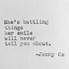 an old typewriter with the words she's battling things her smile will never tell you about