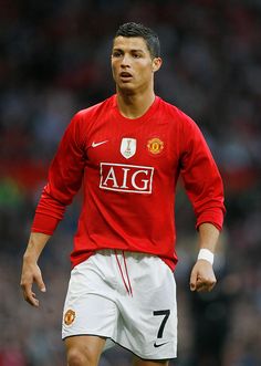 a man in red shirt playing soccer on field