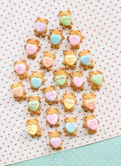 heart shaped cookies arranged in the shape of teddy bears on a paper with hearts and words written on them