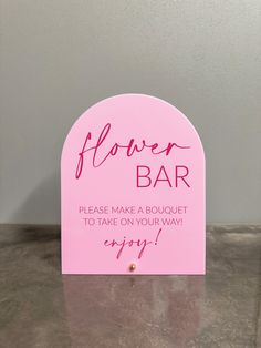 a pink sign that says flower bar please make a bouquet to take on your way