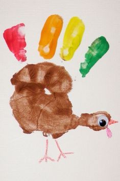 a child's hand painted with different colored crayons and the shape of a turkey