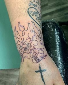 a person's hand with a tattoo on it and a cross in the middle