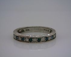 a white gold ring with blue and white diamonds