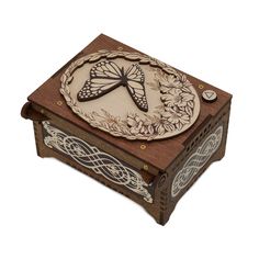 a wooden box with a butterfly on it