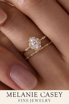 a woman's hand with a diamond ring on her finger and the words melanie casey fine jewelry