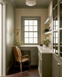 a chair sitting in the middle of a kitchen next to a counter top and cabinets