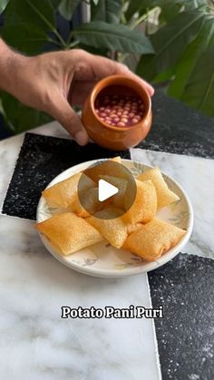 a person is dipping some food into a bowl