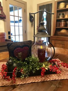 a table topped with a lantern and flowers