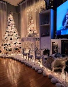 a living room decorated for christmas with white trees and snowman decorations on the floor