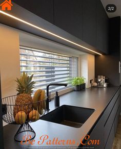 a kitchen with black cabinets and counter tops