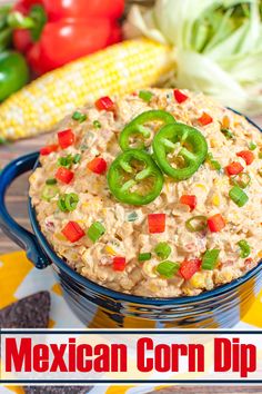 an image of a bowl of dip with peppers and corn on the cob in the background