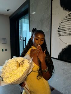 a pregnant woman holding a bouquet of flowers