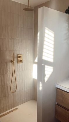 a bathroom with a shower, sink and mirror