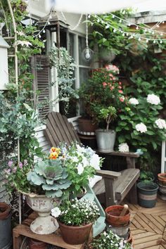 an outdoor patio with potted plants and chairs