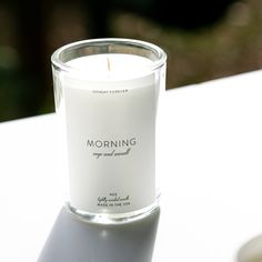 a white candle sitting on top of a table