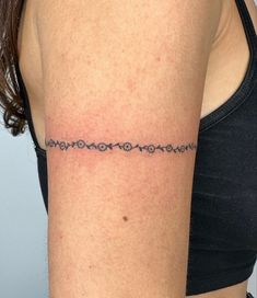 a woman's arm with a small tattoo on the left side of her arm