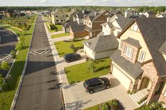 an aerial view of some houses and cars