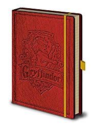 a red harry potter book with gold trim