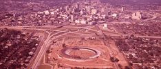 an aerial view of a large stadium in the middle of a city with lots of tall buildings