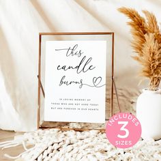 this candle burns sign sits next to a vase with dried grass in it and a white background