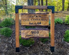 a sign for the coosair's wilderness sits in front of some trees