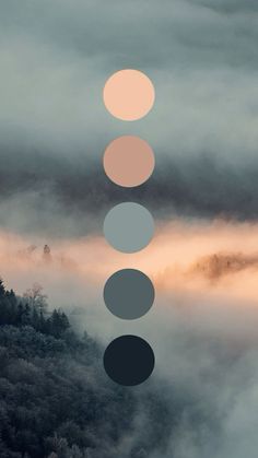 the sky is covered in fog and there are five circles on top of each other