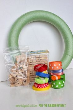 a stack of wooden blocks sitting next to a green wreath