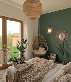 a bedroom with green walls and white bedding, hanging planters on the wall