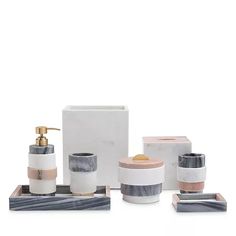 marble bathroom accessories including soap dispenser, toothbrush holder and soap dish