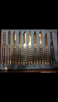 an assortment of knives are displayed in a case