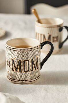 two coffee mugs with the word mom on them