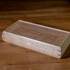 a wooden box sitting on top of a hard wood floor