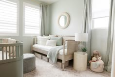 a baby's room with a crib, rocking chair and bed in it