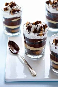 an image of desserts in glasses on a table