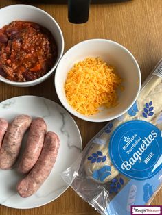 three different types of food are shown in bowls on a table with bread, cheese and other items