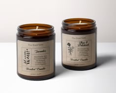 two candles sitting next to each other with labels on them and one candle in the middle