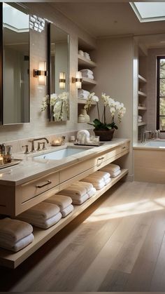 a large bathroom with two sinks and mirrors