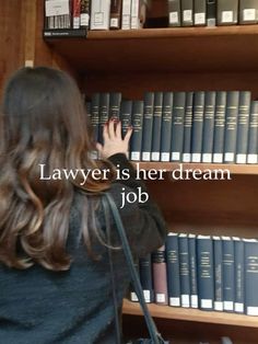 a woman standing in front of a bookshelf with her hand on the bookcase