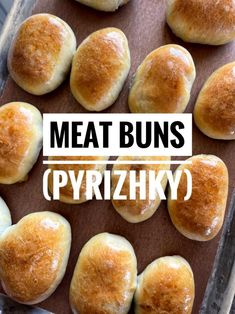 some bread buns on a baking sheet with the words meat buns pyrrizky