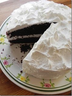 a cake with white frosting on a plate