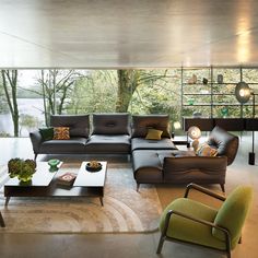 a living room filled with furniture and a fire place in the middle of the room