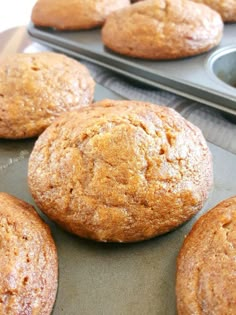 freshly baked muffins lined up on a baking tray