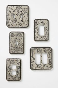 four switch plates with floral designs on them