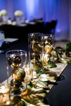 there are many glasses on the table with gold decorations