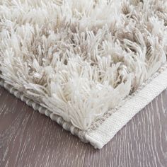 a white rug on top of a wooden floor