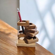 a pen holder made out of wooden blocks