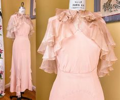 vintage 1930s party dress set, with gown + matching cape. not technically a wedding piece, but would make an exceptional choice for modern bridal-wear!  ➡ muted peach pink rayon crepe, with ecru rayon chiffon fluttering ruffles, layered lavishly ➡ the cape features a layered collar + extremely extra tiered ruffles -- it closes with a hook at the neck  ➡ the gown is extremely curve-hugging + super hot!  ➡ gathered drape across the back shoulders + DEEP plunged bodice sides, just shy of the waistl Dracula Film, Gown Cape, 1930's Dresses, Steps Dresses, Vintage 1930s Dress, Senior Thesis, Cape Set, Mood Clothes, 1930s Dress