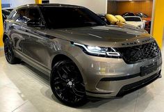 a silver range rover parked in a showroom